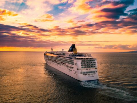 white cruise ship under cloudy sky