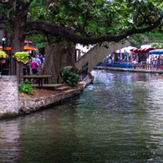 a canal with a bridge over it and people walking on it