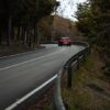 a red car driving down a curvy road