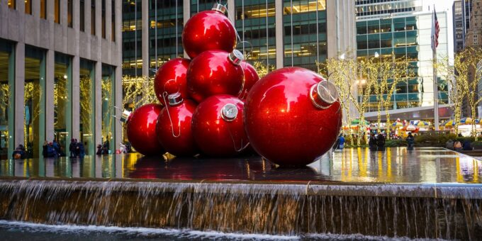 a group of red balls sitting on top of a fountain